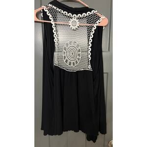 Black vest by New Directions women’s size XL. White crochet details on back.